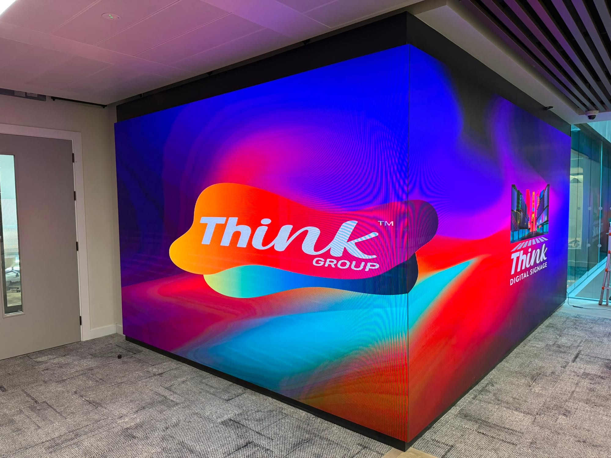 A wraparound corner dvLED wall running branded content across two walls